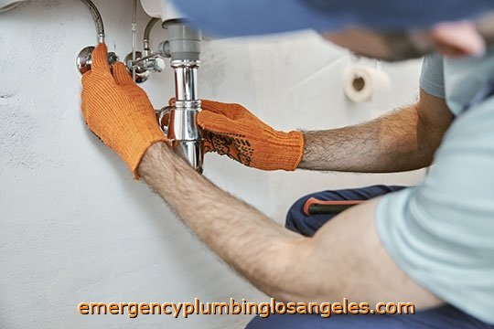 Plumber reparing sink drain pipe Pasadena